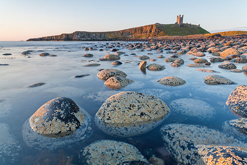 A stunning image of Dunstanburgh Castle, on the Northumberland coast, at sunrise. 