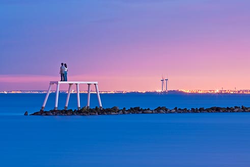 Sean Henry’s off-shore sculpture ‘Couple’ at Newbiggin-by-the-Sea, at dusk.