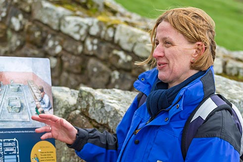Catherine Jarvis of Hands-on-Latin giving a guided tour of Housesteads Fort, Northumberland. 