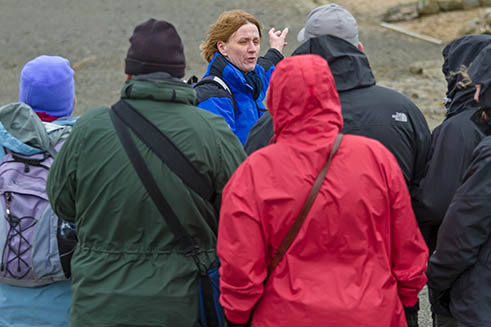 Catherine Jarvis of Hands-on-Latin guiding a group of visitors around Housesteads Fort.
